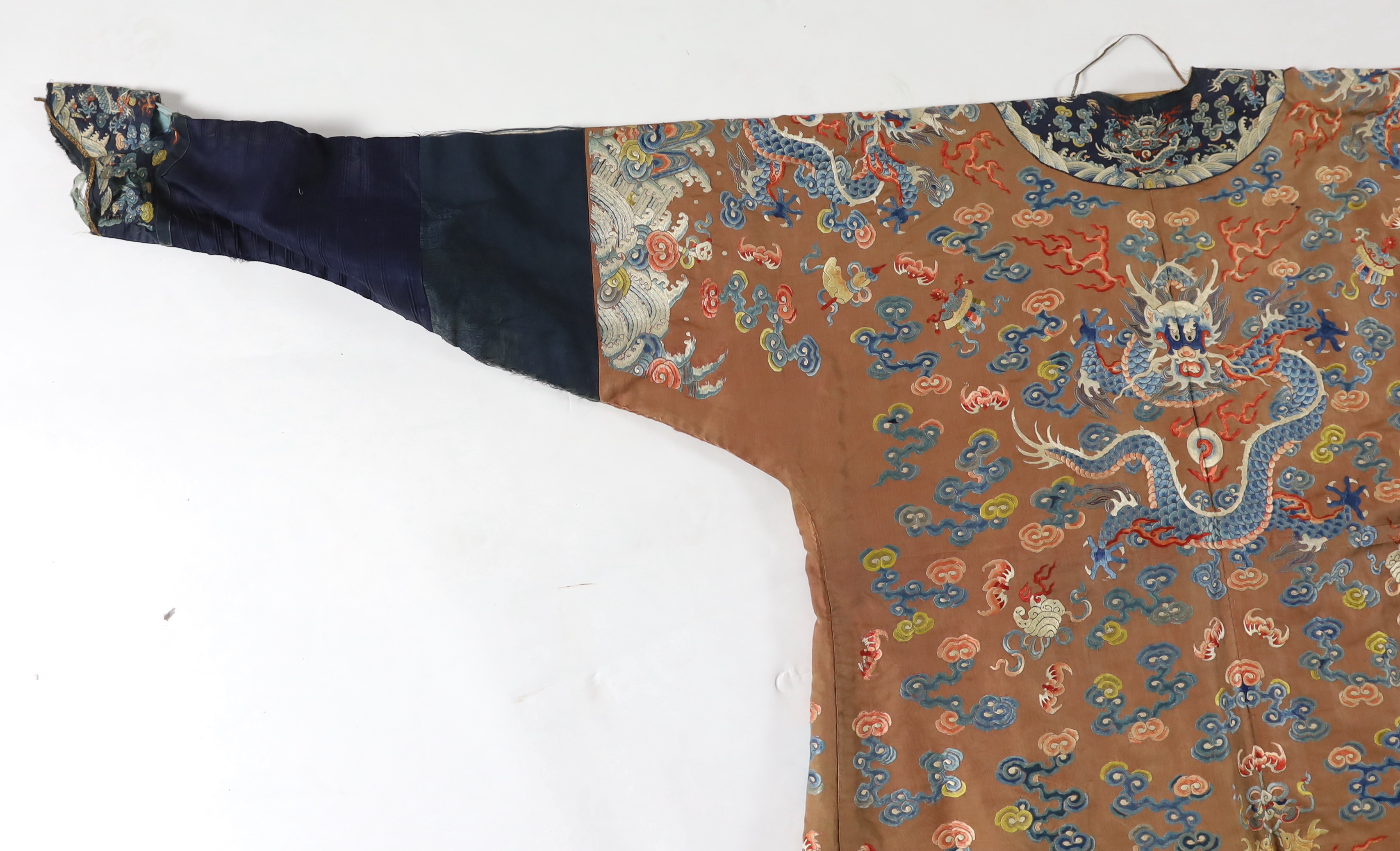 A Chinese chestnut-ground ‘nine dragon’ robe, jifu, 19th century, tears and losses